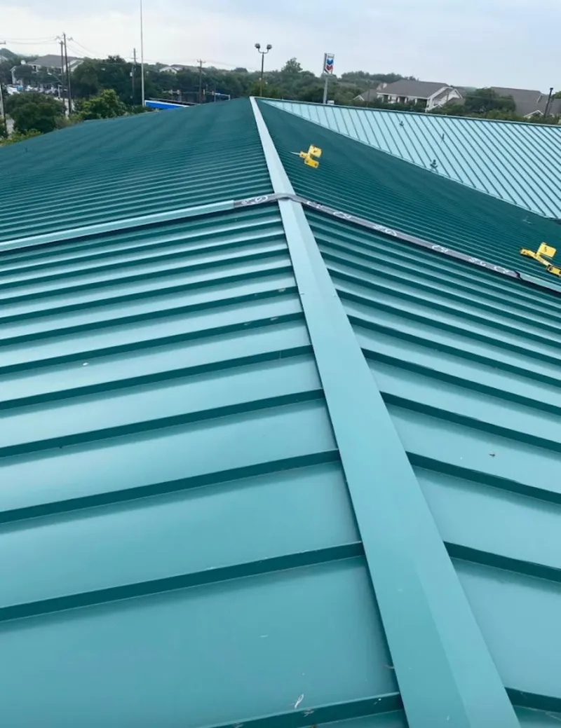 Green commercial metal roof ridge and valley for Metal Roof Repair in Steamboat Springs